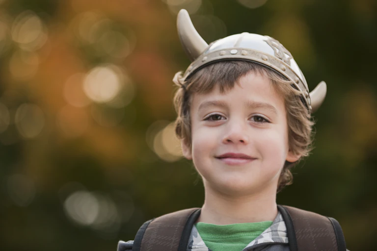 Smiling boy wearing Viking hat with horns