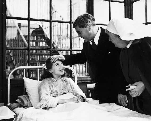 Aneurin Bevan talking to a young female patient