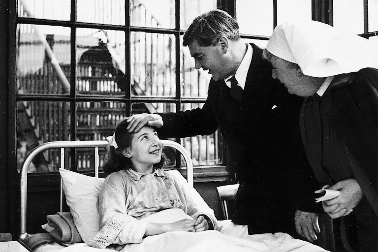 Aneurin Bevan talking to a young female patient