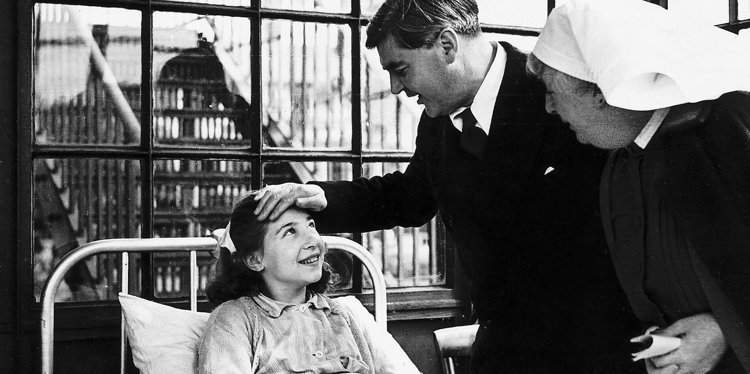 Aneurin Bevan talking to a young female patient