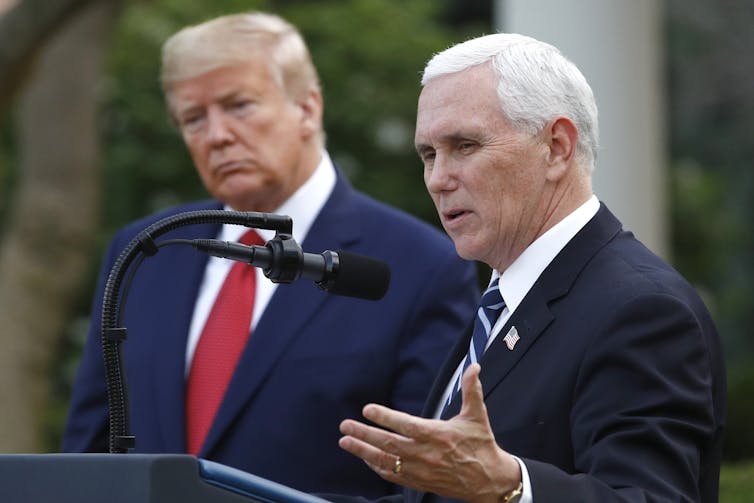 Mike Pence, with Trump behind him.