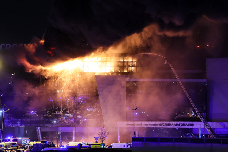 Flames and smoke are seen billowing from a buuilding.