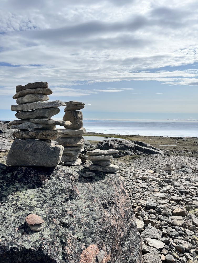 A landscape with Inukshuks in the foreground