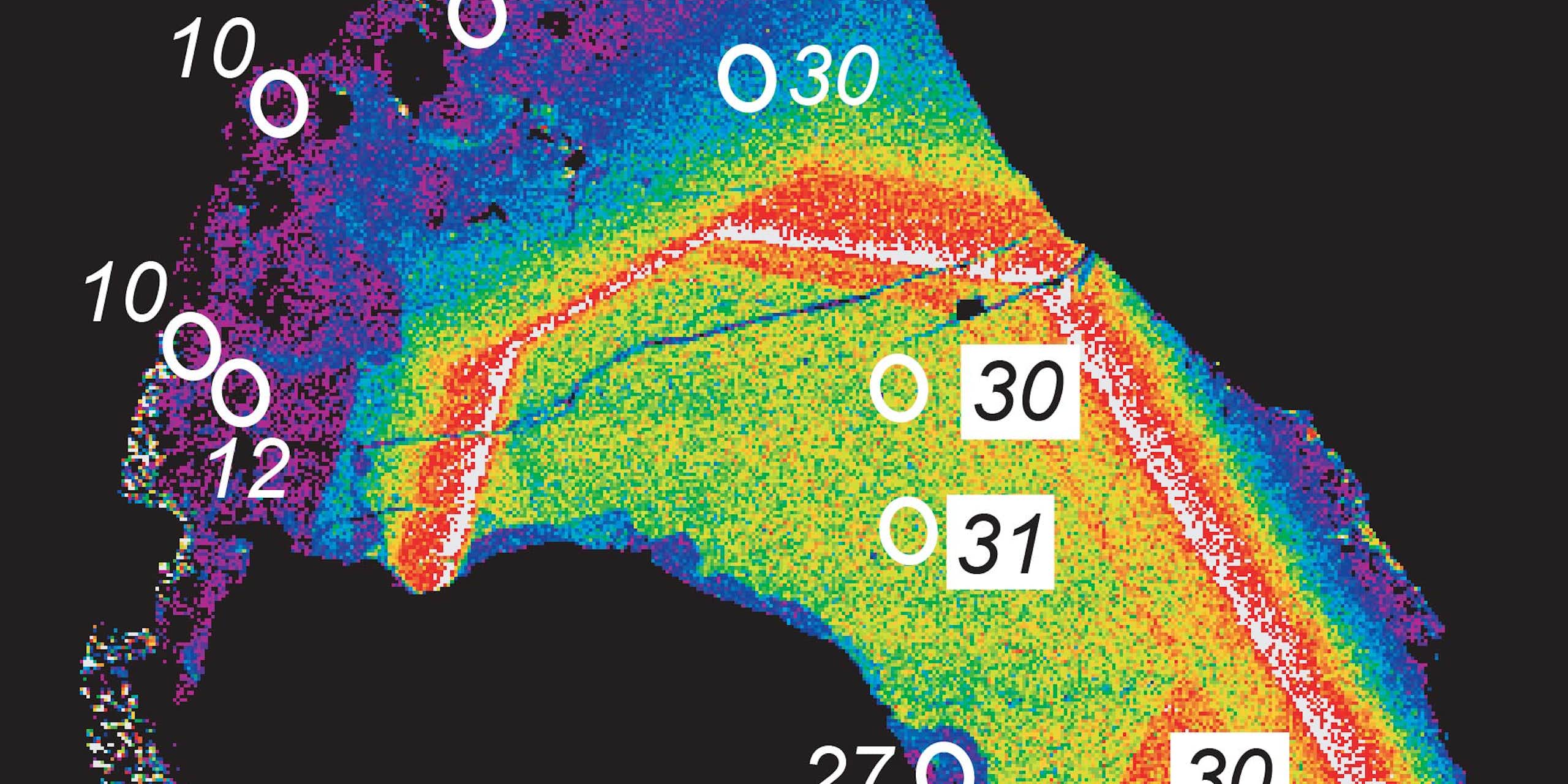 Microscopy heat map of an oblong sliver, with violet at the edges and yellow toward its center, with numbers indicating millions of years superimposed.