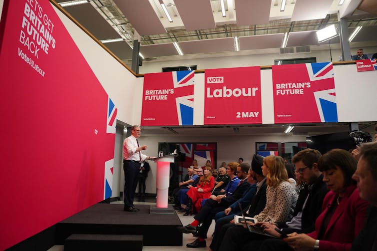 Keir Starmer gives a speech in front of a banner reading 'Britain's Future'.