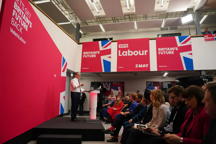Keir Starmer giving a speech in front of a banner that reads 'Britain's future'.