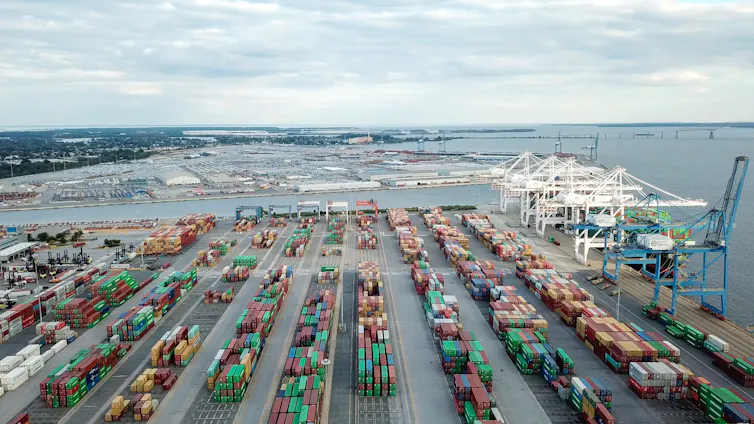 a shipyard with rows of shipping containers