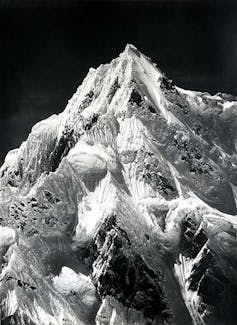 Black and white photo of a snow covered peak