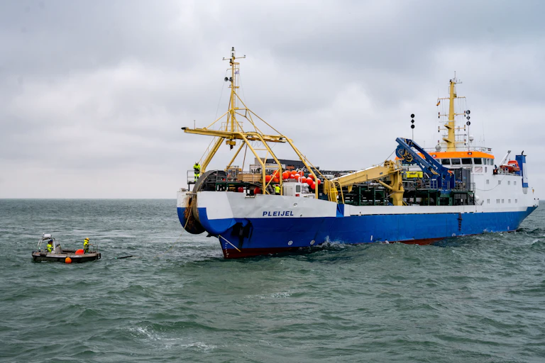 A ship with a vertical spool mounted in its bow