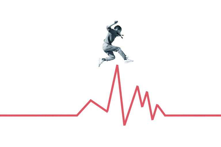 Person jumping over the peak of a jagged red line