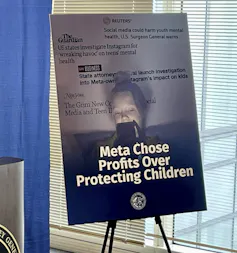 A sign on a board that says 'Meta chose profits over harming children.'