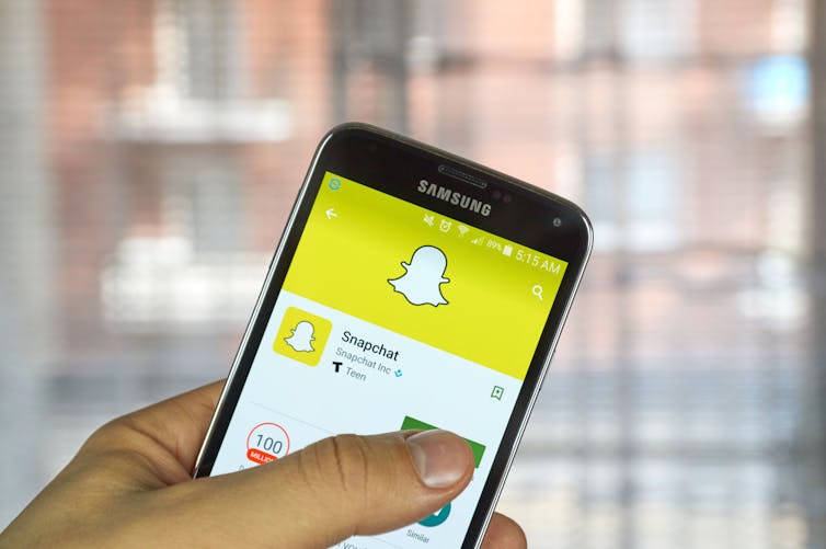 Apps seen on a smartphone in a person's hand.