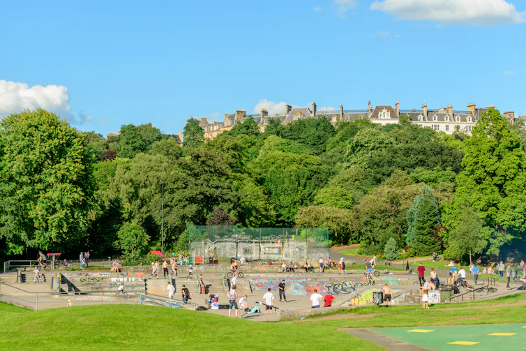 Young people at a skate park on a sunny day.