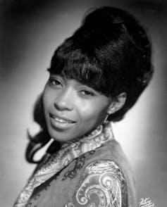 Black and white portrait of a young Black woman with beehive hairdo.