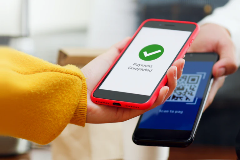 Photo of QR code payment, customer using smartphone for paying at shop