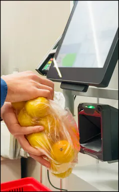 Customer pays his purchase at self service checkout