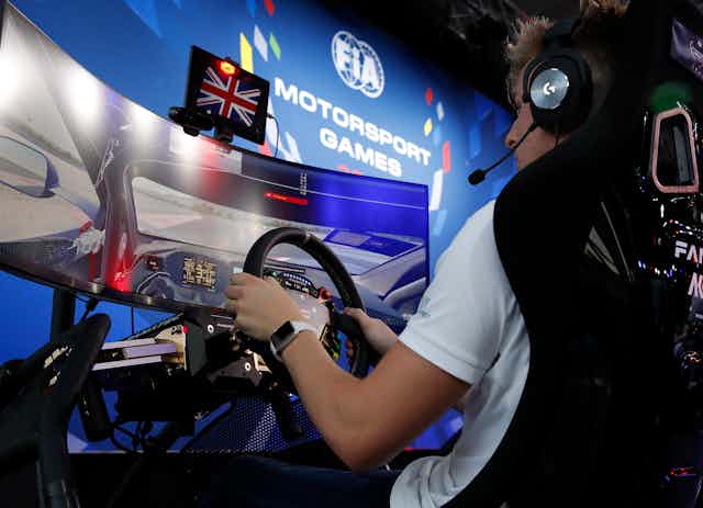 A man competes in a motorsport event during an esports competition.