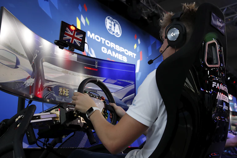 A man competes in a motorsport event during an esports competition.