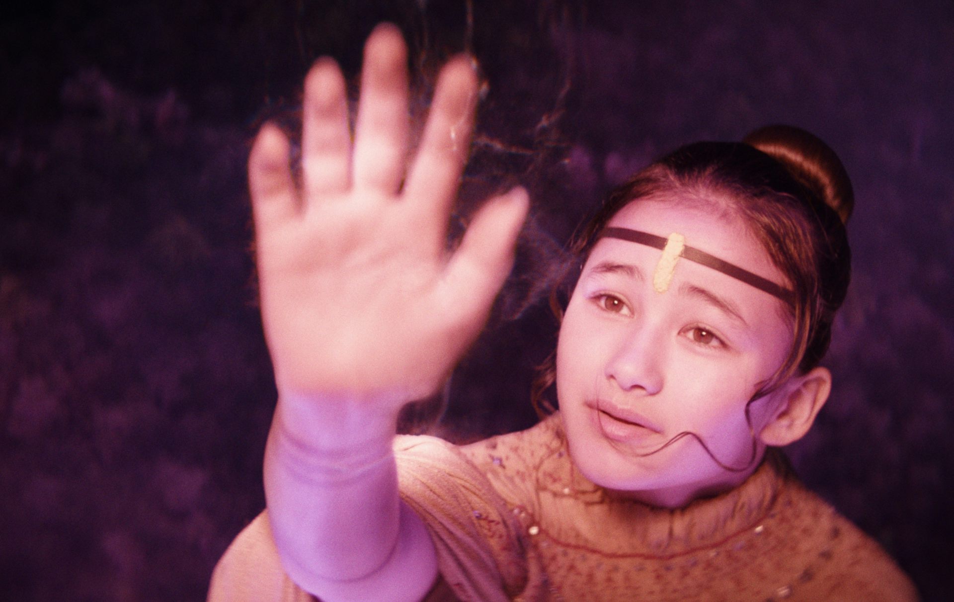 Young girl holds her hand to the sky