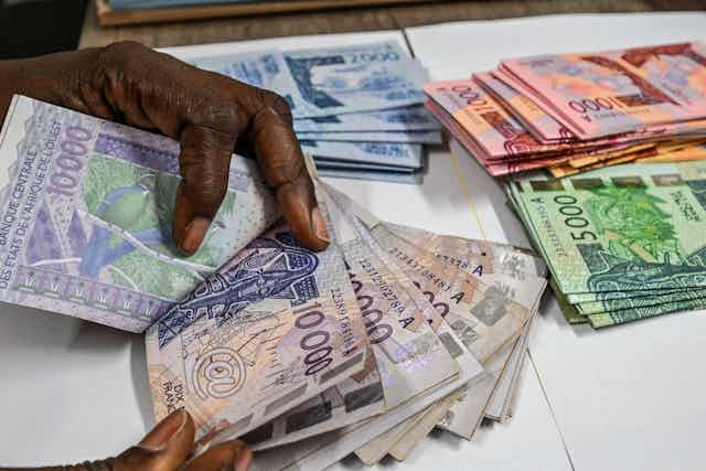 Hands sorting through banknotes