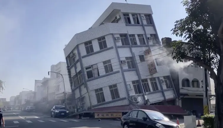 Partially collapsed buildings sit in a street in Taiwan.