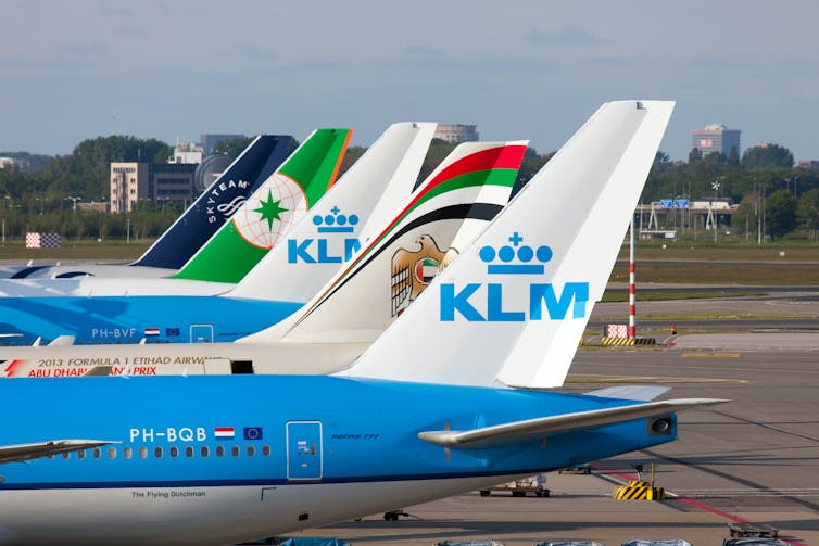KLM and Etihad planes parked side by side at an airport