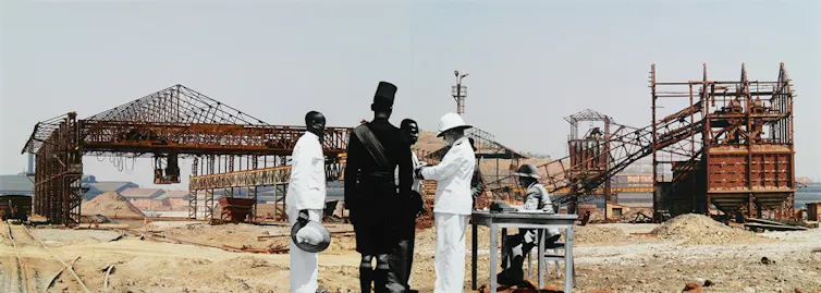 Men in colonial-era garb in front of a mine shaft.
