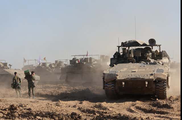 Israeli troops and tanks assemble outside the Gaza Strip, March 2024.