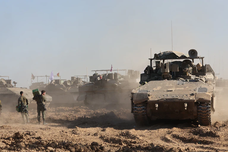 Israeli troops and tanks assemble outside the Gaza Strip, March 2024.
