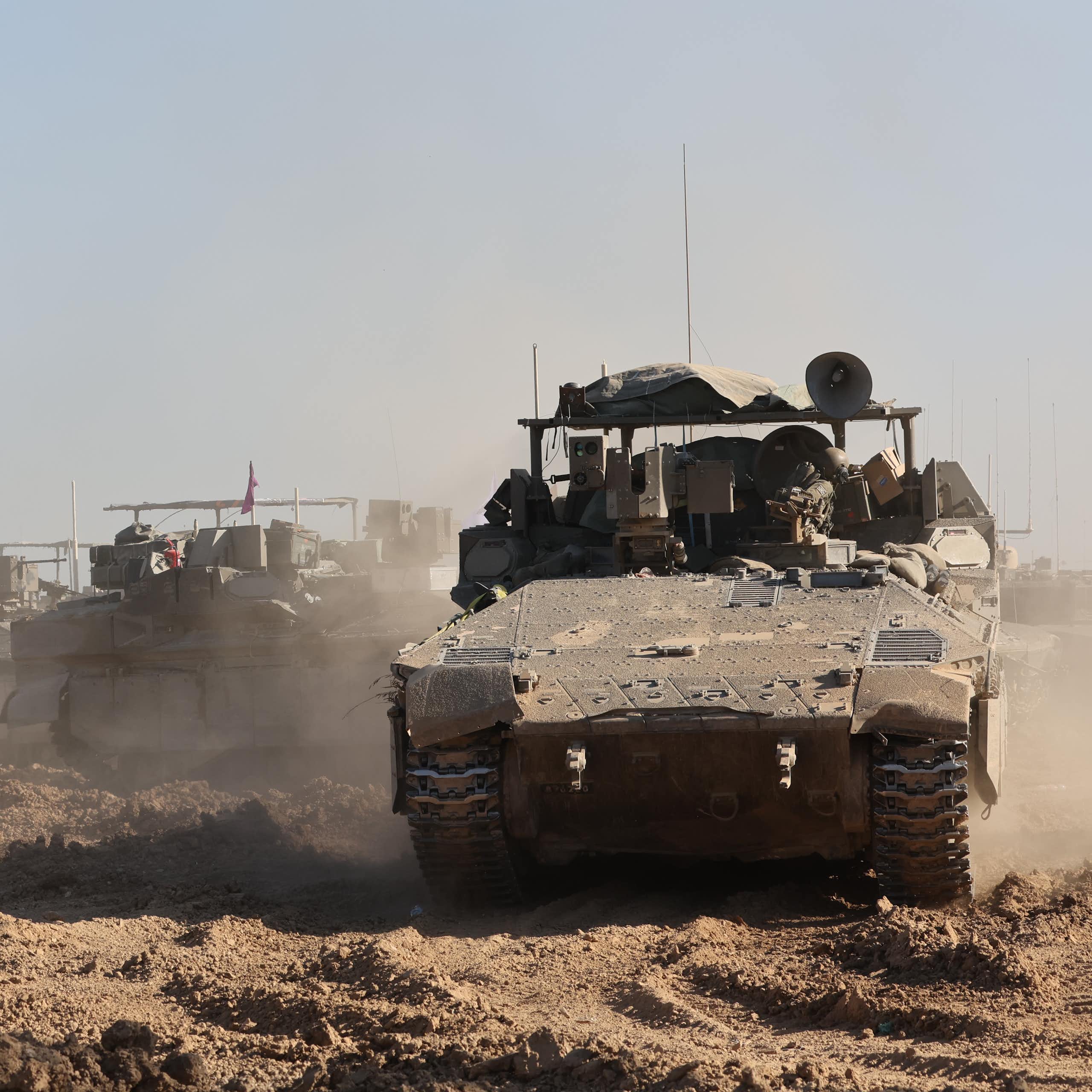 Israeli troops and tanks assemble outside the Gaza Strip, March 2024.