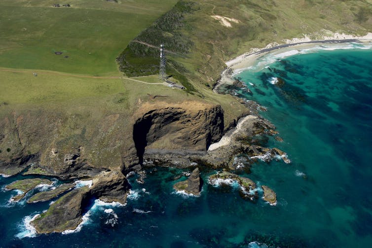 Aerial image of the air monitoring station at Kennaook/Cape Grim in Tasmania, view from the ocean looking towards the cliffs