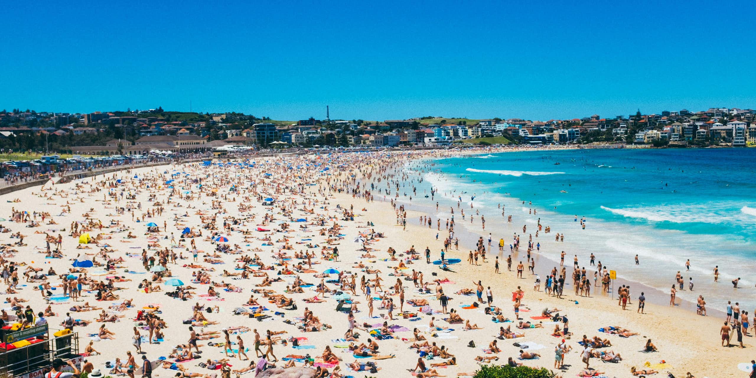 Sunbathers and swimmers on Bondi Beach on a sunny day in Sydney, Australia