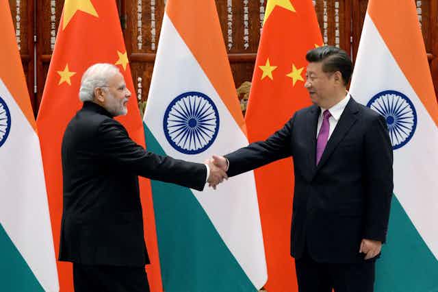Modi and Xi shake hands