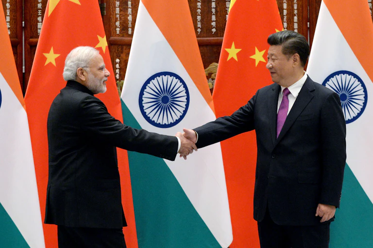 Modi and Xi shake hands