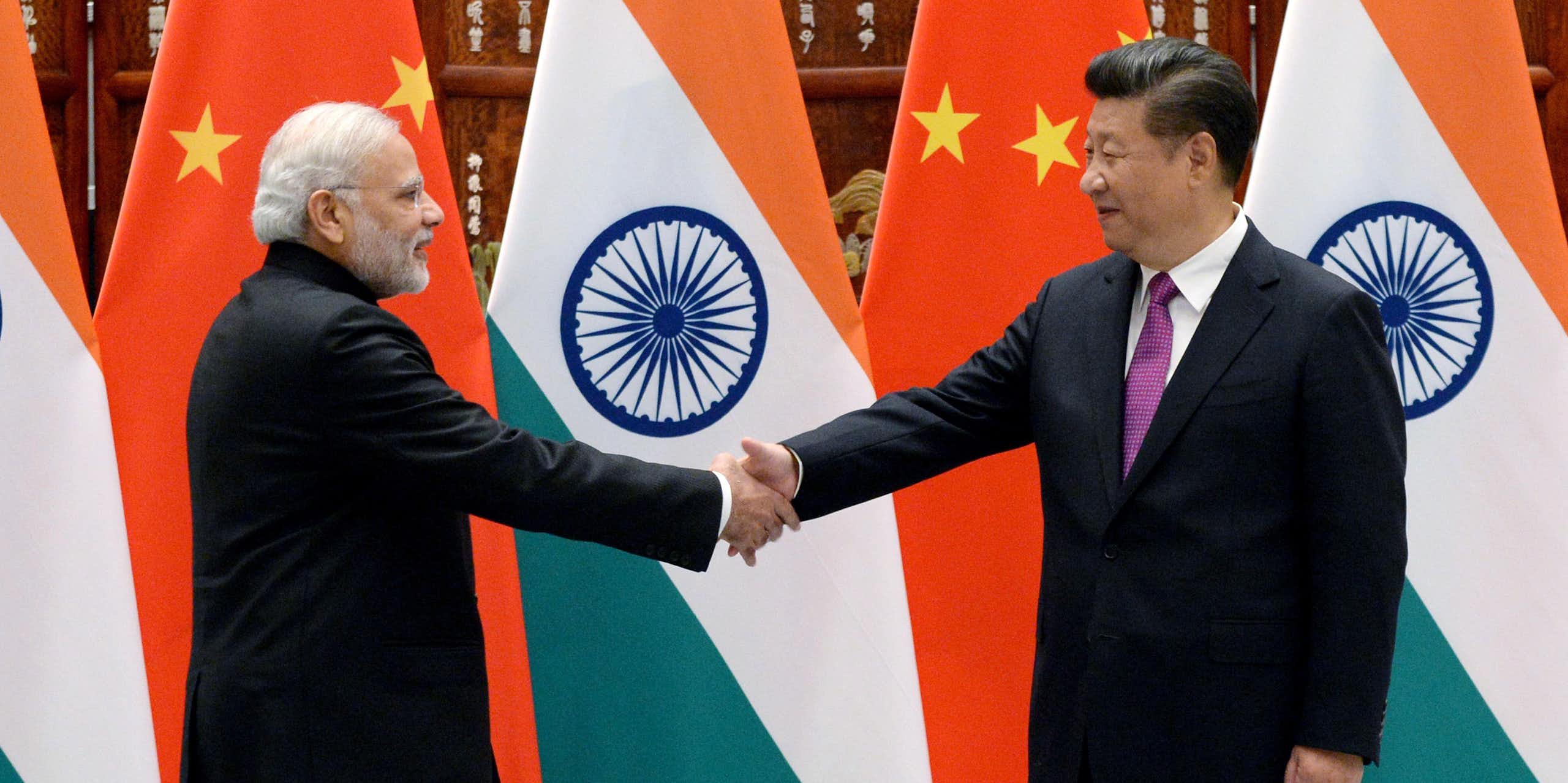 Modi and Xi shake hands