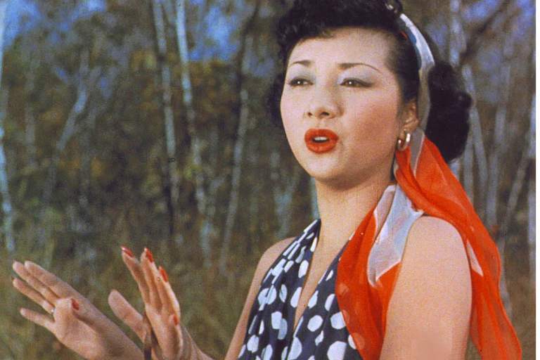 Hideko Takamine as Carmen with bright red lipstick and a scarf in her hair