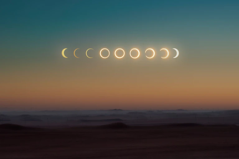 a desert sky with all phases of the solar eclipse in a row