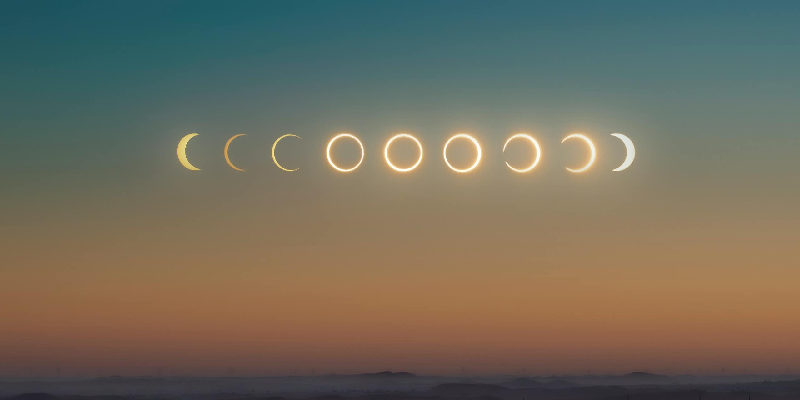 a desert sky with all phases of the solar eclipse in a row