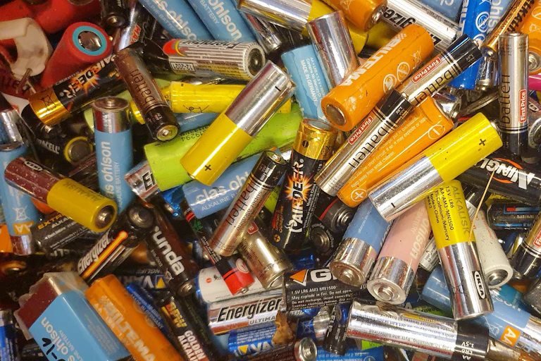 a jumble of different color and size household batteries