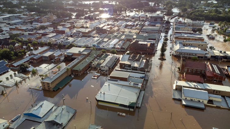 A drone image shows Lismore drenched in floodwater.