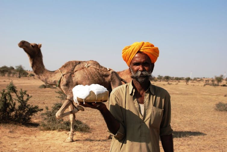 Man holds camel milk bowl
