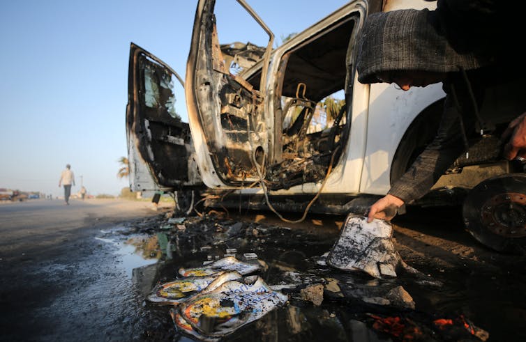 The wreckage of a vehicle that has been bombed and burned.