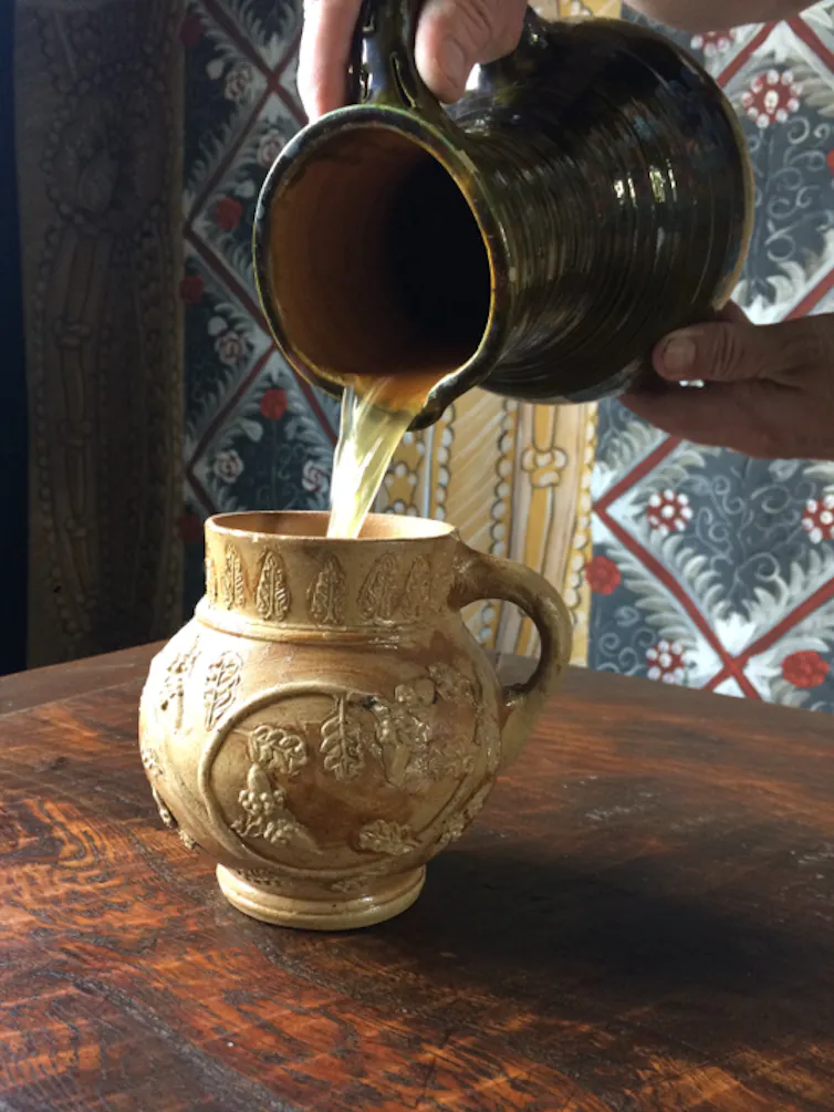 A jug pouring out the recreated beer.