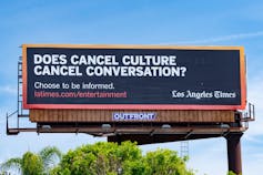 A billboard that says Does Cancel Culture Cancel Conversation in white letters against a blue backdrop.