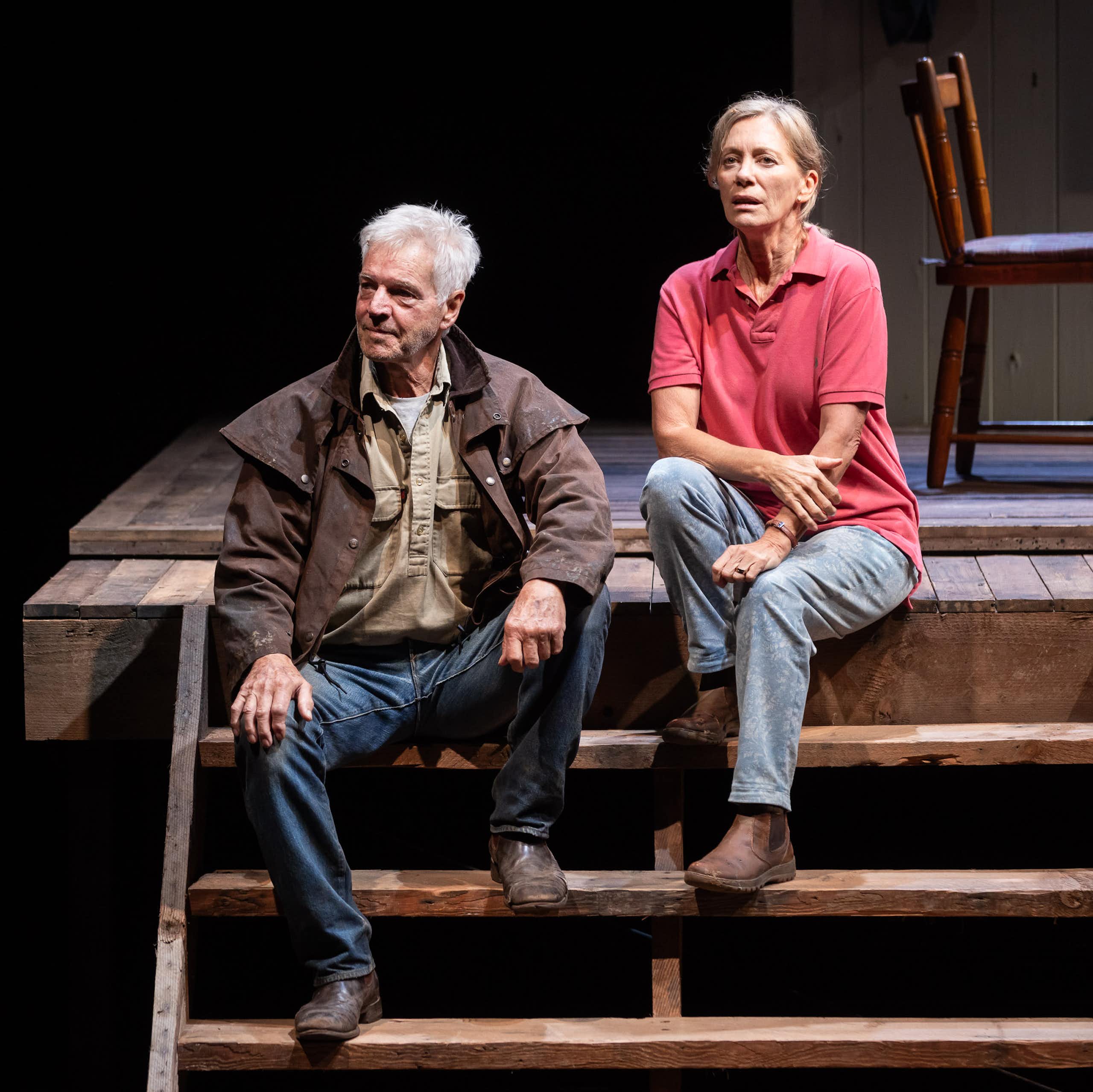 Production image: a couple sit on wooden steps