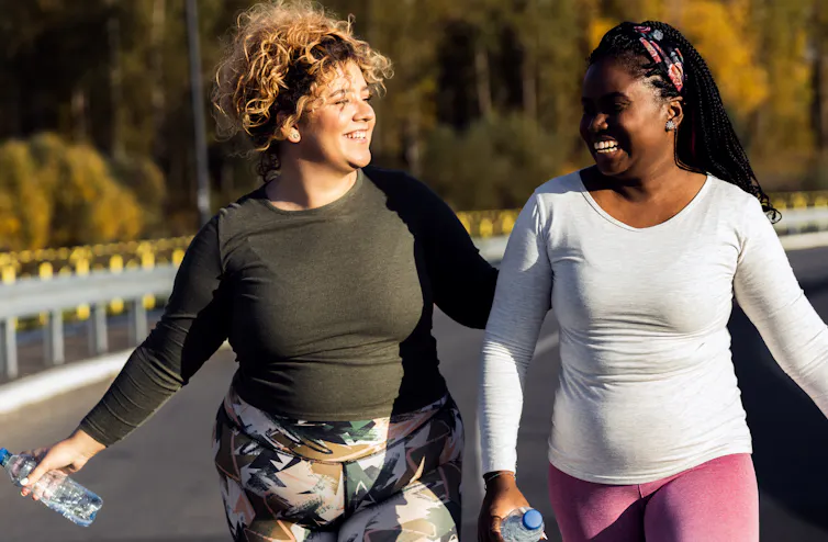Women walk and smile