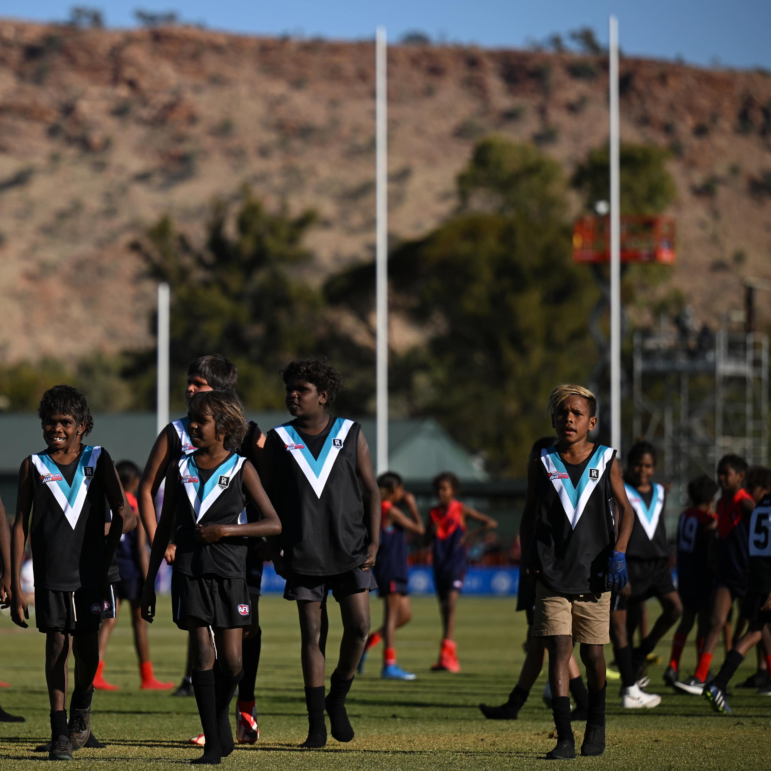 Young AusKick players walk off the field at  Traeger Park in Alice Springs