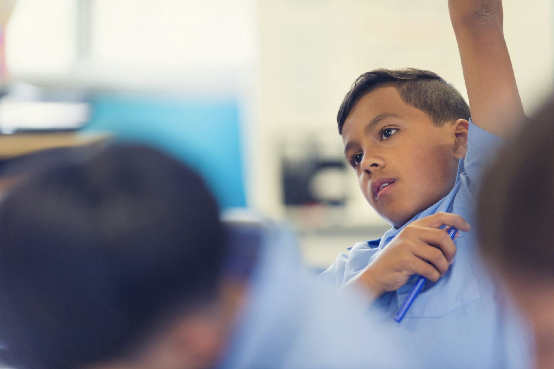 A student raises his hand in class