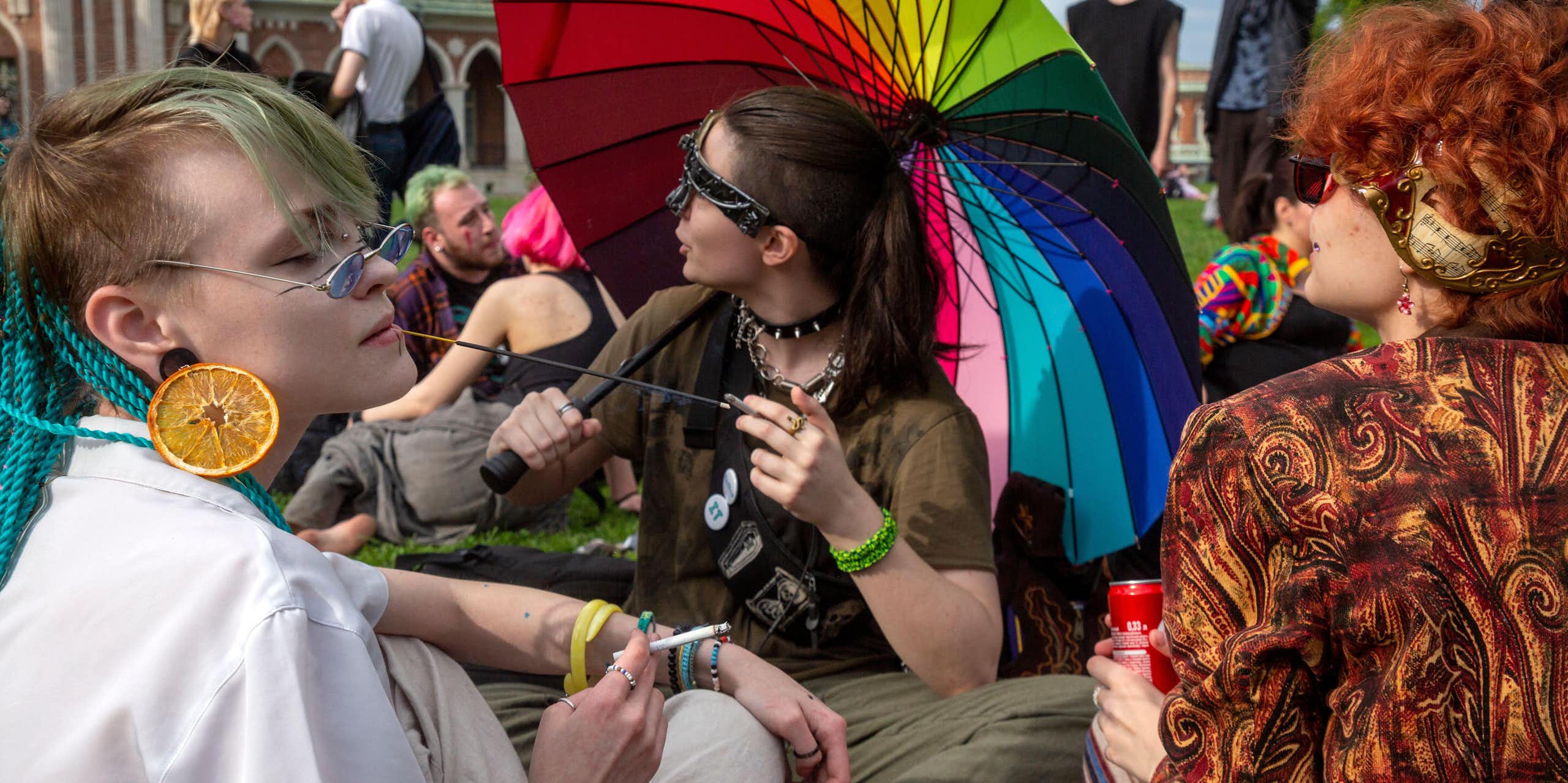 Young people gather in a park in Moscow wearing rainbow and other LGBT symbols