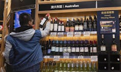 Man browses australian wines in a shop in China